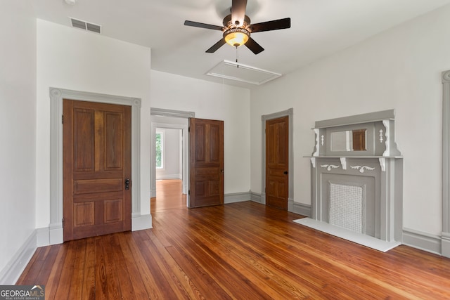 unfurnished living room featuring hardwood / wood-style flooring and ceiling fan