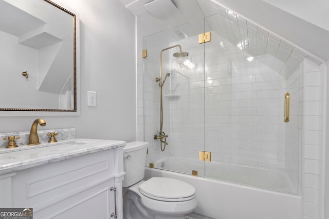 full bathroom featuring shower / bath combination with glass door, vanity, and toilet