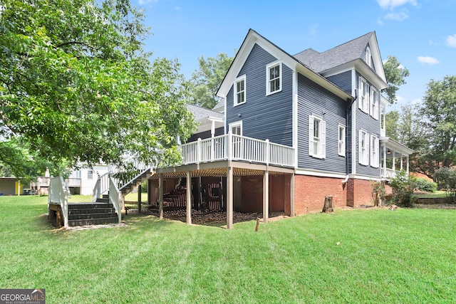 back of property featuring a wooden deck and a lawn