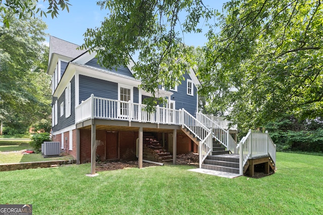 rear view of property featuring a wooden deck, central AC unit, and a lawn