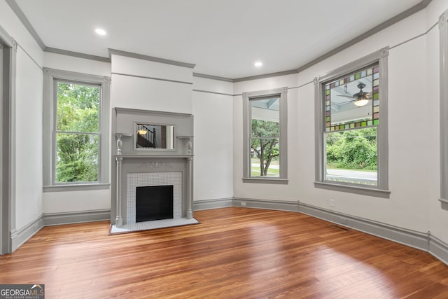 unfurnished living room featuring crown molding and light wood-type flooring