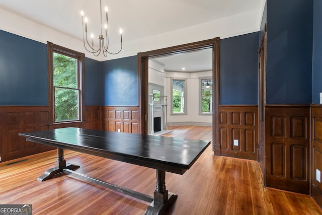 playroom featuring wood-type flooring and an inviting chandelier