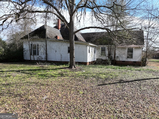 rear view of property with a lawn