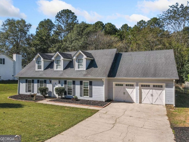 cape cod-style house featuring a garage and a front lawn