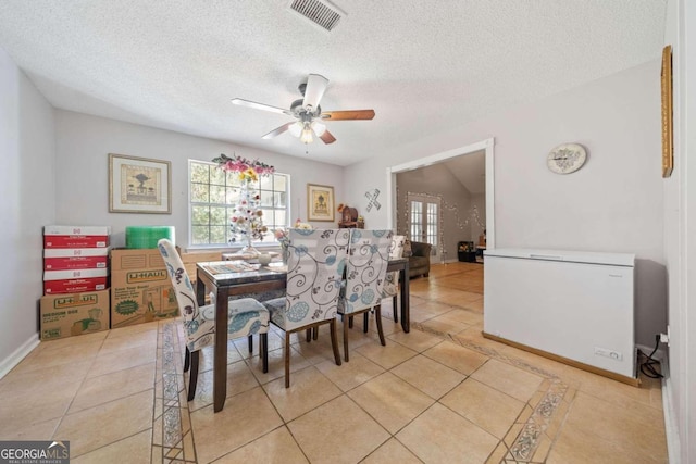 dining room with ceiling fan, a textured ceiling, and light tile patterned floors