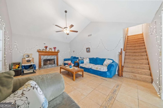 tiled living room featuring lofted ceiling and ceiling fan