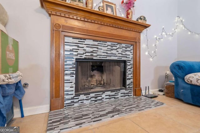 room details featuring tile patterned flooring, tasteful backsplash, and a tile fireplace