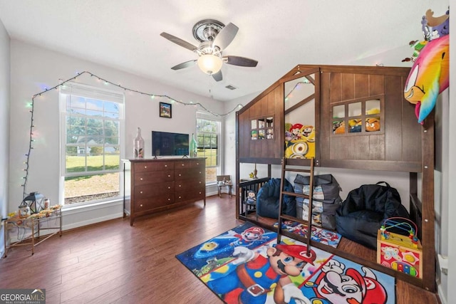 bedroom with multiple windows, ceiling fan, and dark hardwood / wood-style floors