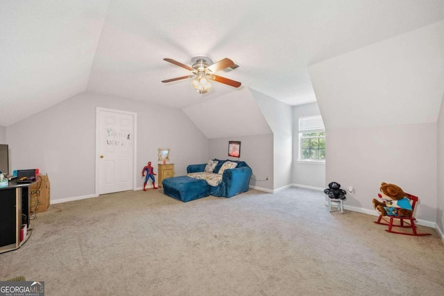 recreation room featuring light colored carpet, vaulted ceiling, and ceiling fan