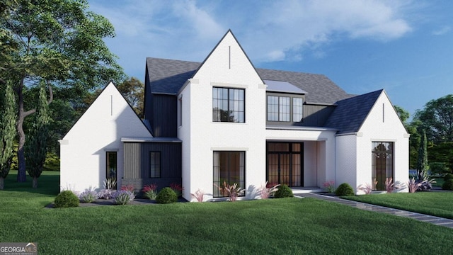 modern farmhouse style home with brick siding, a shingled roof, and a front lawn