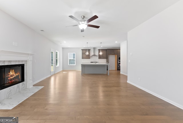 4060 Holstein Hl Unit 104, Columbus, GA 31904 - unfurnished living room featuring recessed lighting, light wood finished floors, a high end fireplace, baseboards, and ceiling fan