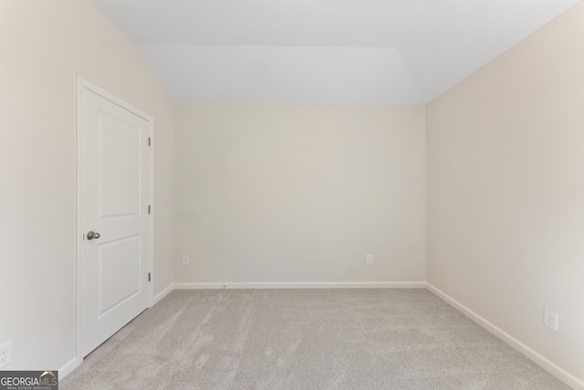 4060 Holstein Hl Unit 104, Columbus, GA 31904 - spare room with baseboards, lofted ceiling, and light carpet