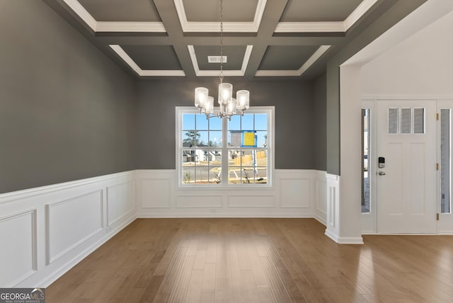 4060 Holstein Hl Unit 104, Columbus, GA 31904 - unfurnished dining area with wainscoting, visible vents, a notable chandelier, beamed ceiling, and wood finished floors