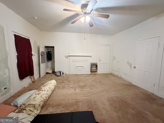 living room featuring light carpet, a fireplace, and ceiling fan