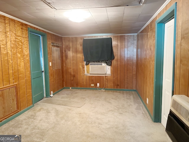 carpeted spare room featuring wooden walls, cooling unit, and heating unit