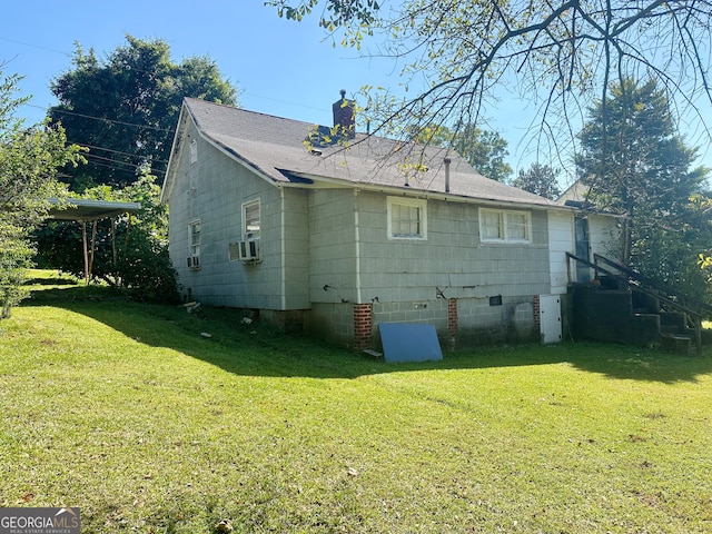 view of side of home with cooling unit and a yard