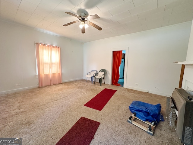 exercise area with ceiling fan and carpet