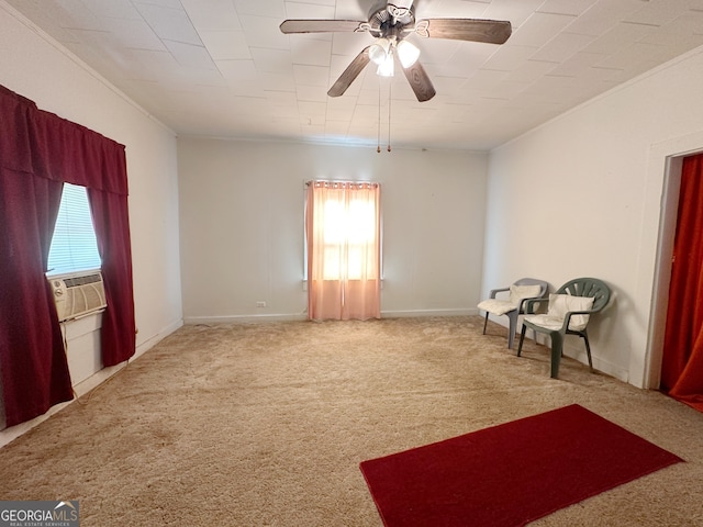 sitting room with ornamental molding, ceiling fan, and carpet floors