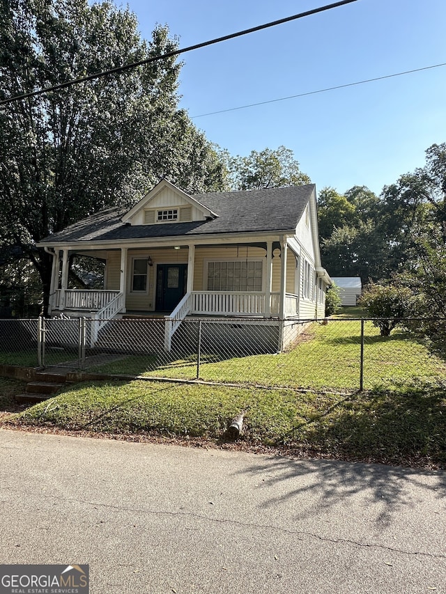 view of front of home featuring a front yard and a porch