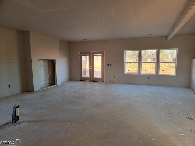 unfurnished room featuring beamed ceiling