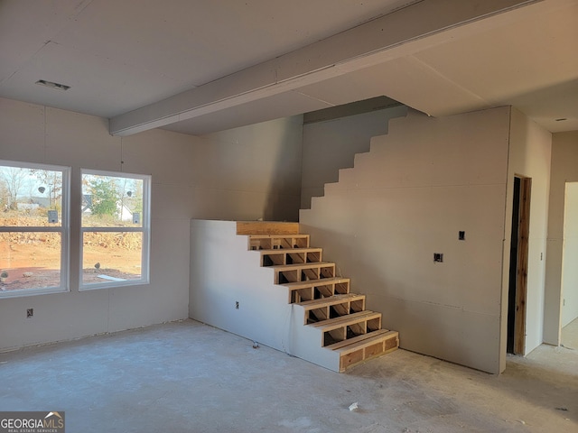 stairway with concrete flooring