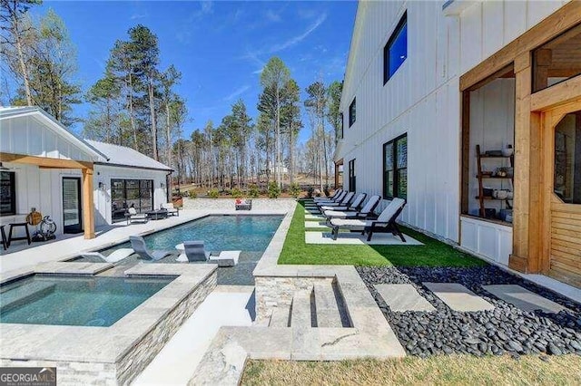 view of swimming pool with an in ground hot tub and a patio