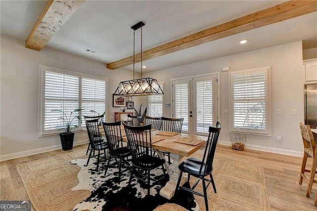 dining area with beamed ceiling, french doors, light hardwood / wood-style floors, and plenty of natural light