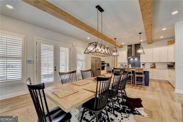 dining room featuring french doors, beamed ceiling, and light hardwood / wood-style floors