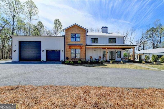 view of front of house featuring a porch and a garage