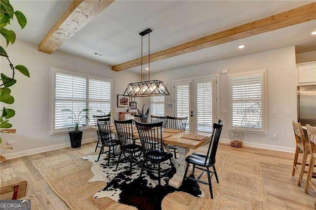 dining area with a wealth of natural light, french doors, beamed ceiling, and light wood-type flooring