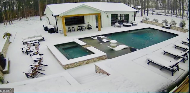 view of pool with an in ground hot tub