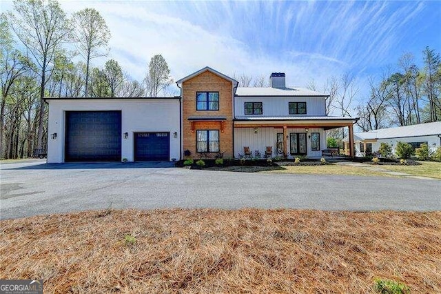 view of front of home featuring covered porch and a garage