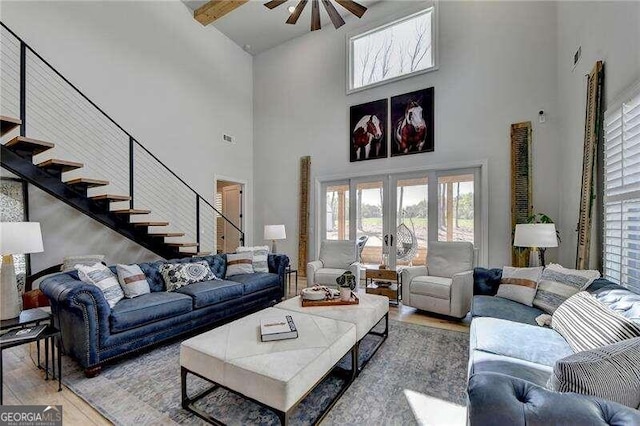 living room with french doors, high vaulted ceiling, and wood-type flooring