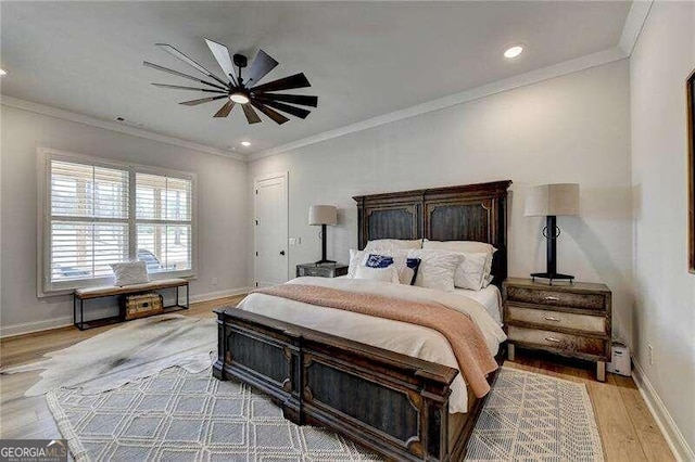 bedroom with ceiling fan, light hardwood / wood-style floors, and crown molding