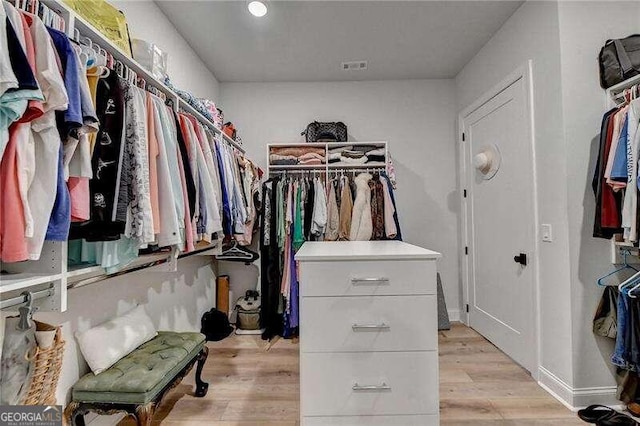 walk in closet featuring light hardwood / wood-style flooring