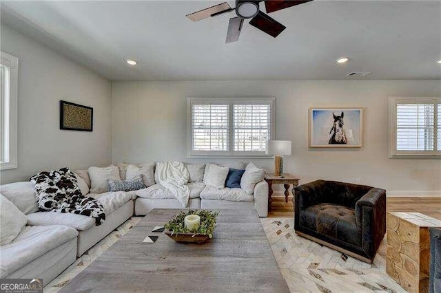 living room with light hardwood / wood-style flooring and ceiling fan