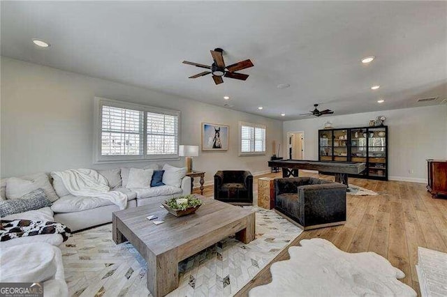 living room featuring ceiling fan, light wood-type flooring, and pool table