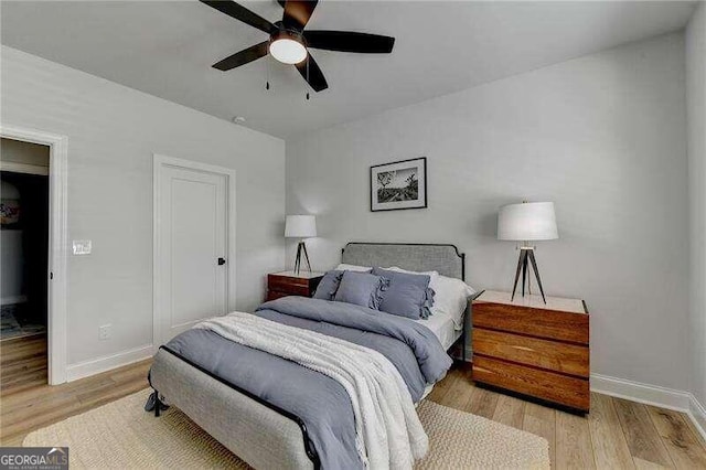 bedroom featuring light hardwood / wood-style floors and ceiling fan