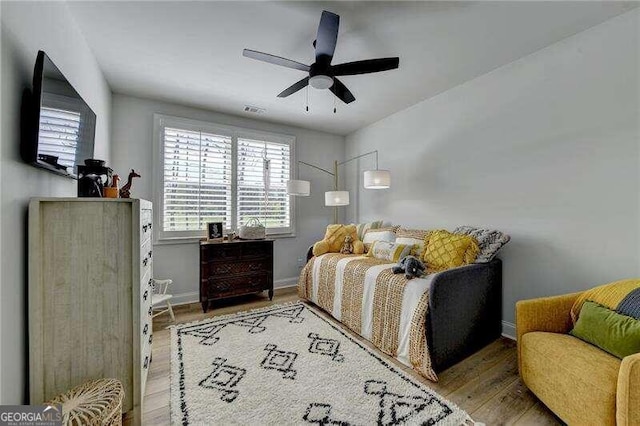 bedroom with ceiling fan and light hardwood / wood-style flooring