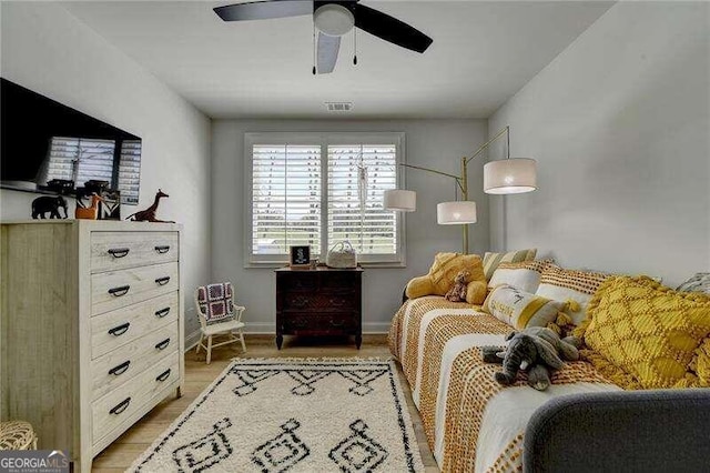 bedroom with ceiling fan and light hardwood / wood-style flooring