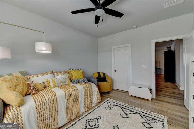 bedroom featuring hardwood / wood-style floors and ceiling fan