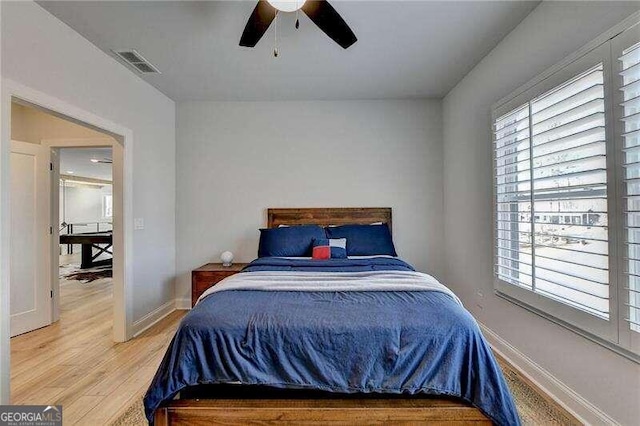 bedroom with ceiling fan and wood-type flooring