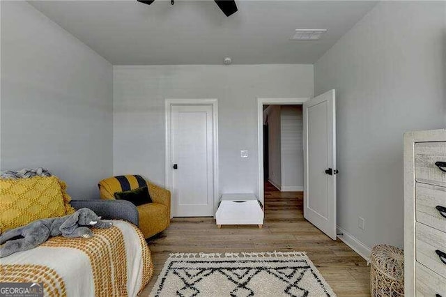 bedroom with light hardwood / wood-style flooring and ceiling fan