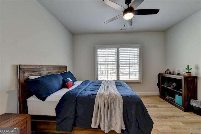 bedroom with light hardwood / wood-style floors and ceiling fan