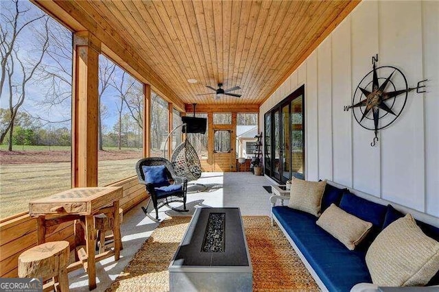 sunroom / solarium featuring ceiling fan and wooden ceiling