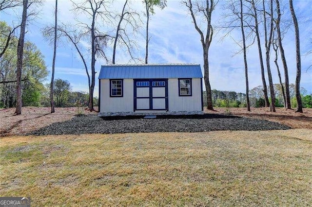 view of outbuilding with a yard