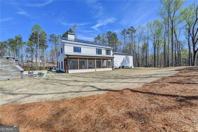 back of house with a sunroom