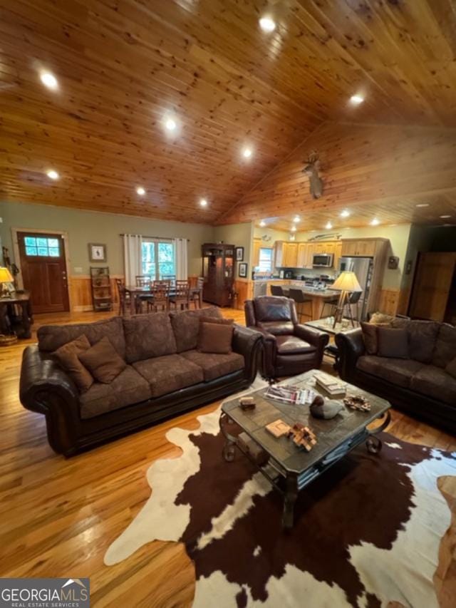 living room with light wood-type flooring, high vaulted ceiling, and wooden ceiling