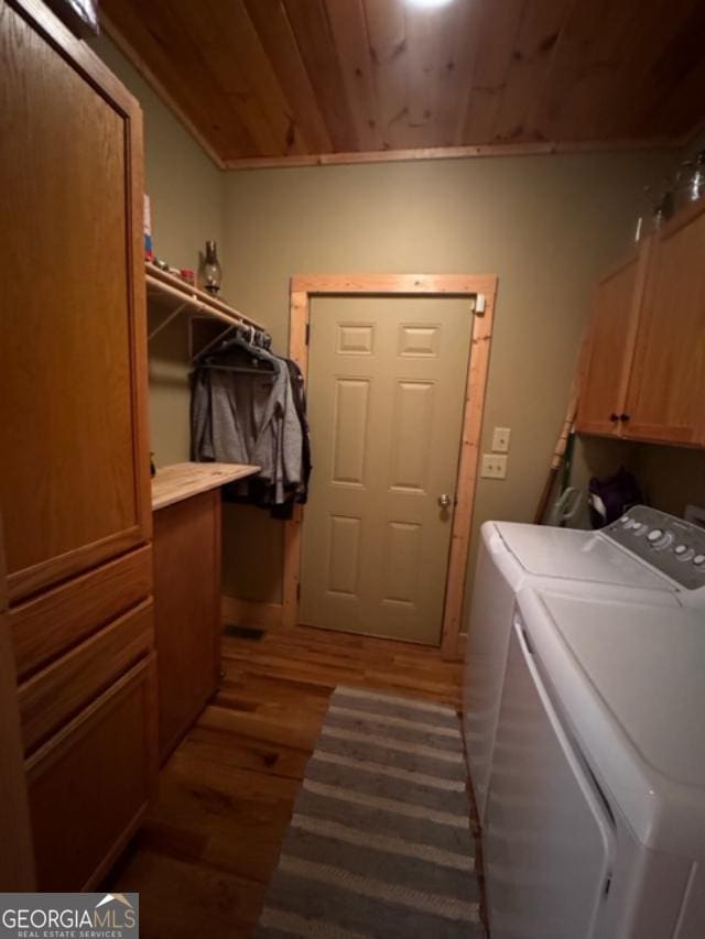 laundry area featuring washing machine and dryer, wooden ceiling, cabinets, and dark hardwood / wood-style flooring