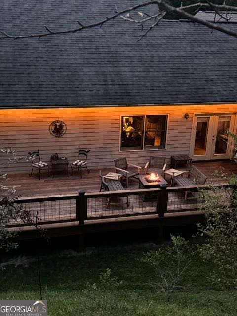 back of house featuring french doors and a deck